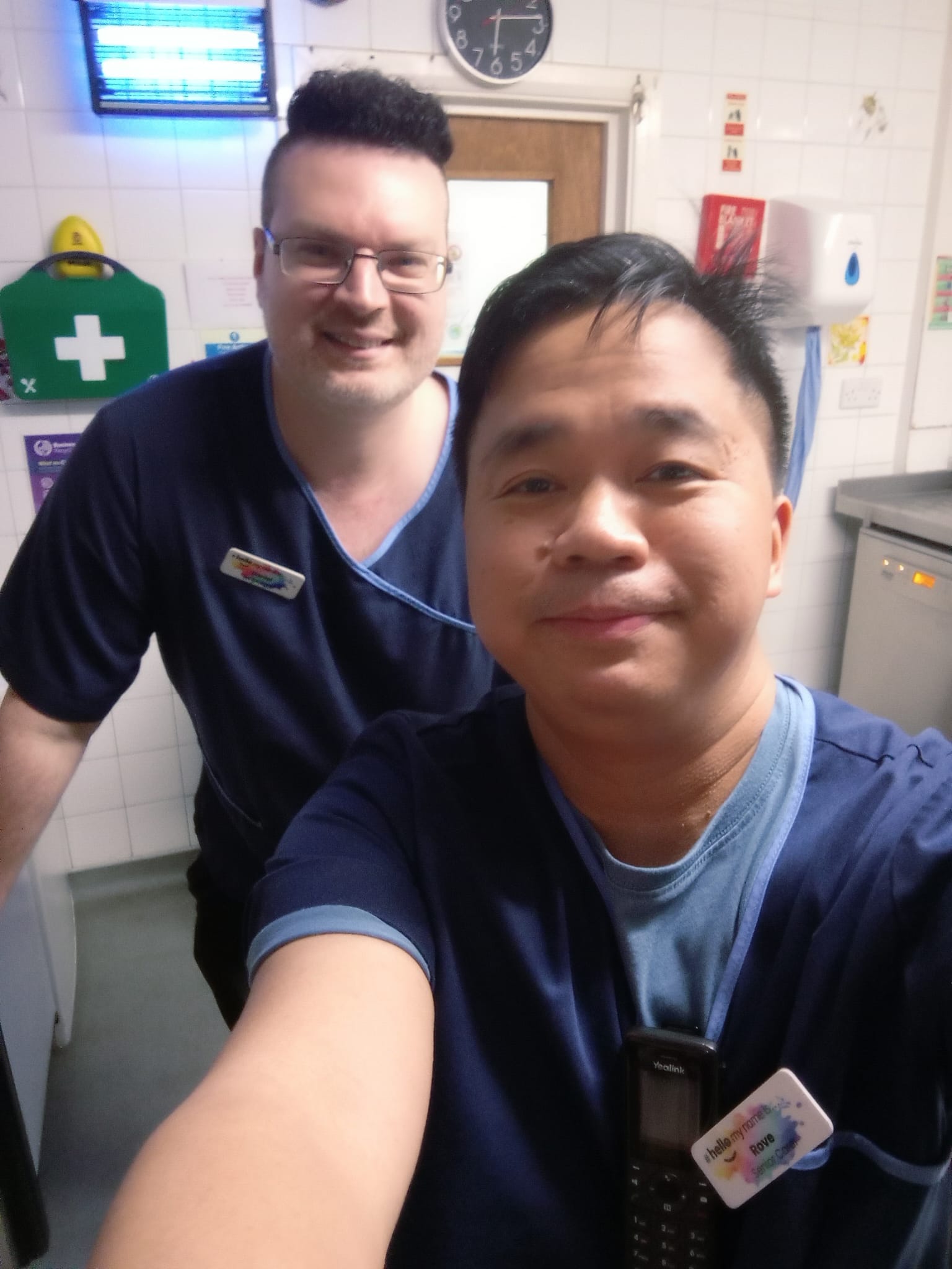 Two Arun Lodge team members standing together in festive attire